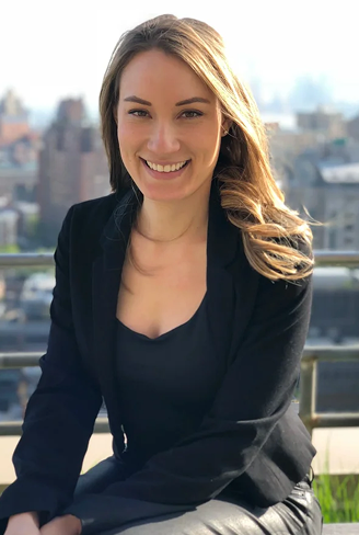 Female business consultant smiling outdoors in professional attire
